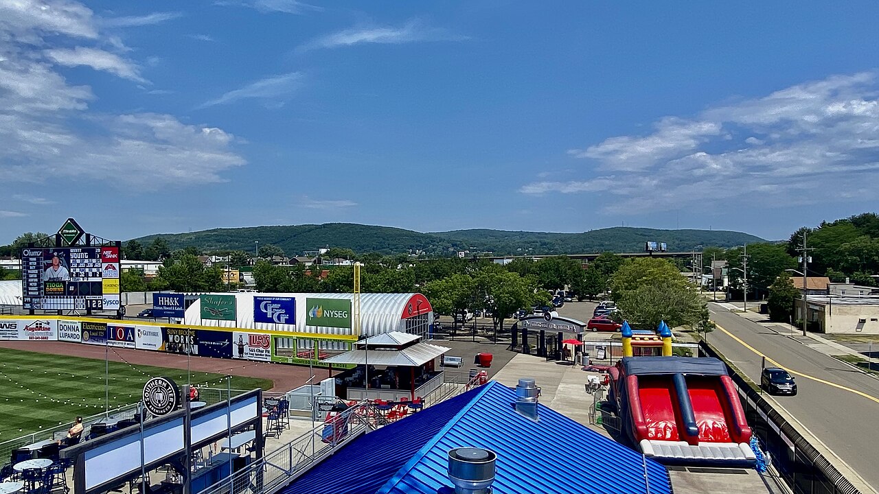A Rumble Ponies game at Mirabito Stadium seen from the upper deck, with green hills beyond the outfield.